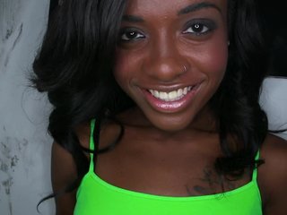Black Chick Is Teasing A Large Dick In A Glory Hole And She Smiles